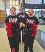 Prior to their performance, Unified Cheerleading Athletes took a moment to pose.  Pictured are:  Anna Russell, Adrian Small, and Ari Myers.