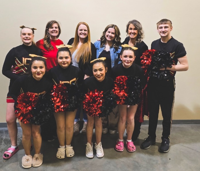 The JCC Varsity Cheerleading Squad with Coaches Andrea Jaquez & Amber Baehr and with Cheer U Coreographers Amber Henson & Danielle Cathey, at 2025 State Cheer.