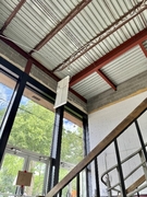 North stairs with exposed ceiling.